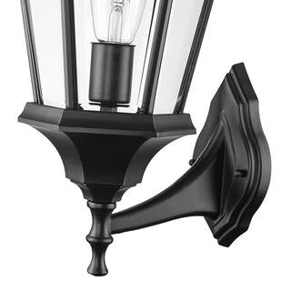 A traditional exterior wall mount featuring durable cast aluminum construction, clear glass panes, and a wet safety rating.